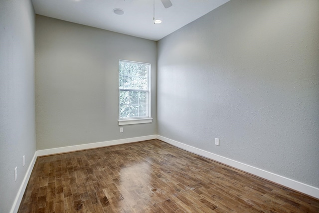 spare room with wood-type flooring and ceiling fan