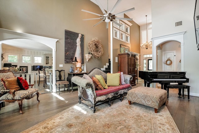 living room featuring hardwood / wood-style flooring, high vaulted ceiling, and ceiling fan