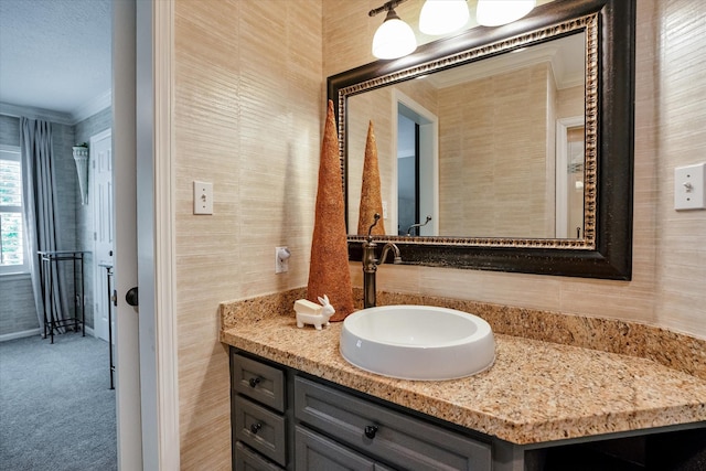 bathroom with vanity and ornamental molding