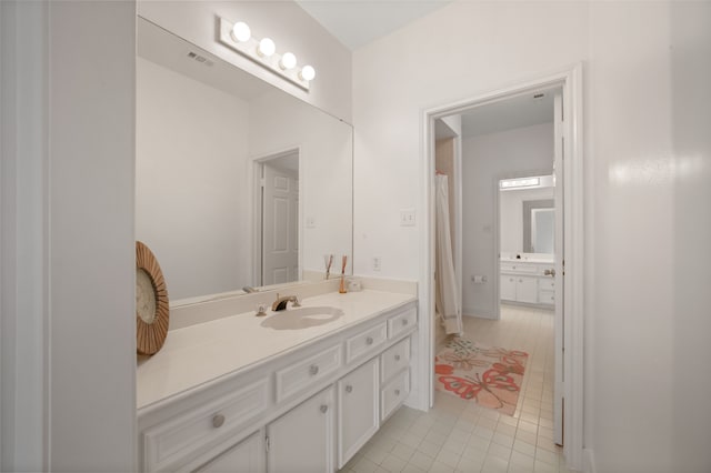 bathroom with tile patterned flooring and vanity