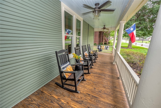 wooden terrace featuring ceiling fan and a porch