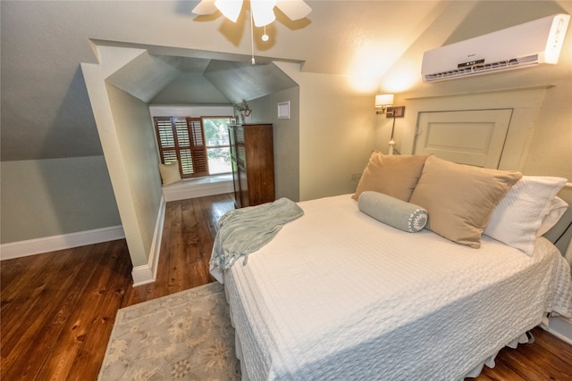 bedroom with ceiling fan, dark wood-type flooring, a wall unit AC, and vaulted ceiling