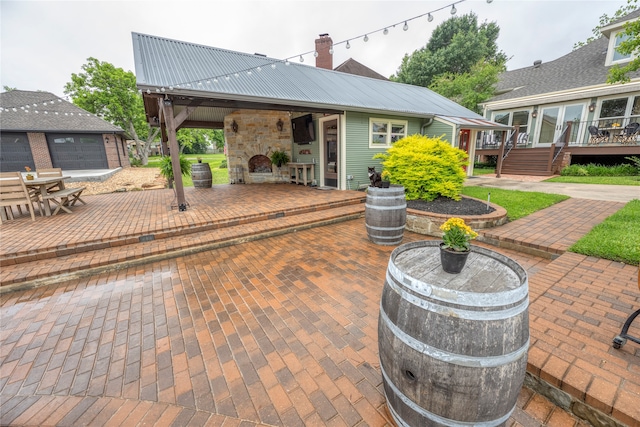 view of patio / terrace featuring an outdoor stone fireplace