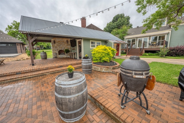 view of patio featuring a fireplace and a wooden deck