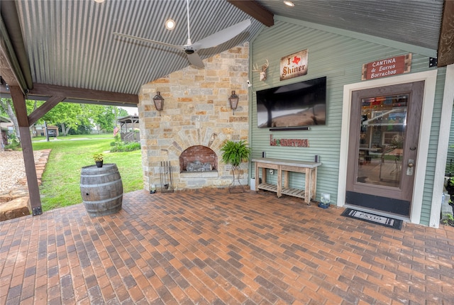 view of patio featuring an outdoor stone fireplace