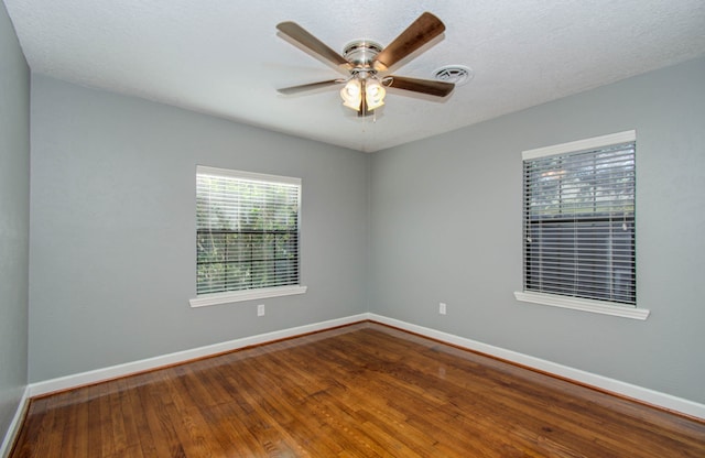 spare room featuring a textured ceiling, ceiling fan, and dark hardwood / wood-style floors