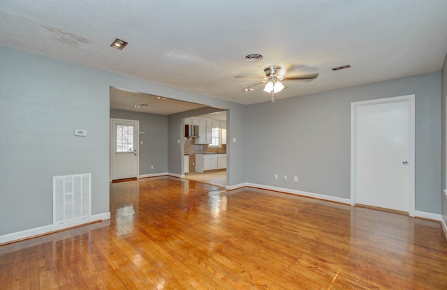 spare room featuring ceiling fan and light hardwood / wood-style floors