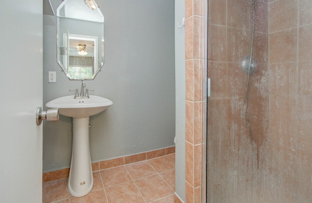 bathroom with tile floors and a shower