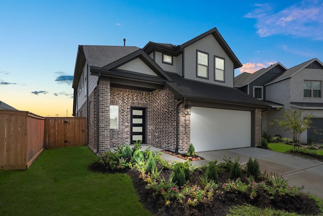 view of front of property featuring a yard and a garage