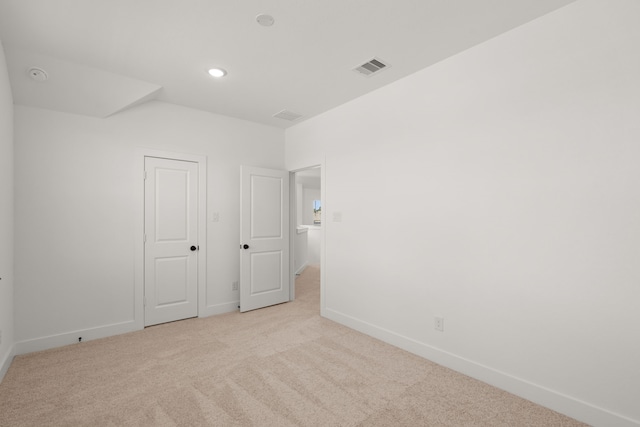 unfurnished bedroom with light colored carpet