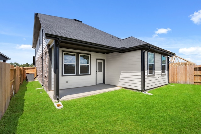 back of property with a patio and a yard