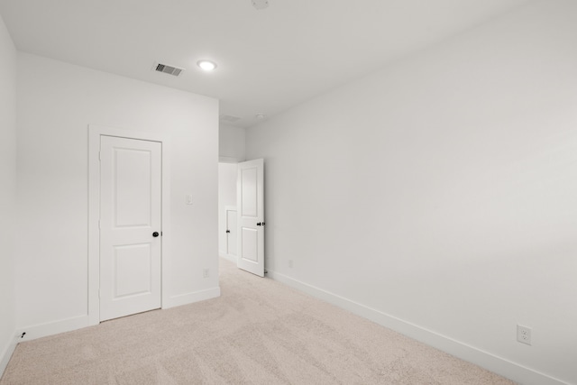 unfurnished bedroom featuring light carpet