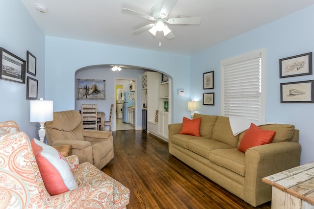 living room featuring dark hardwood / wood-style floors and ceiling fan