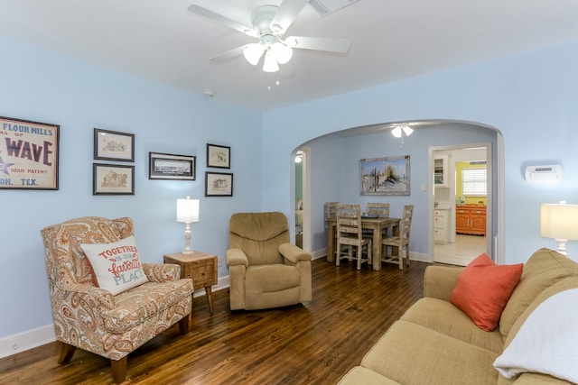 living room with wood-type flooring and ceiling fan