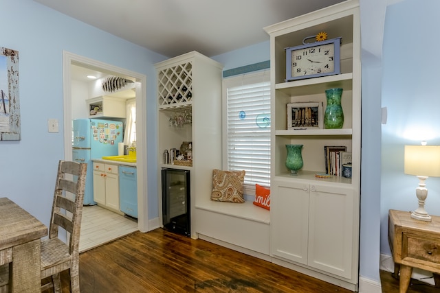 interior space with dark hardwood / wood-style floors and beverage cooler