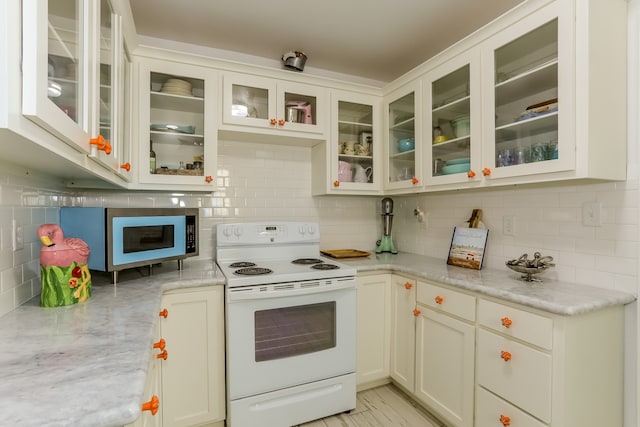 kitchen featuring light stone countertops, backsplash, and white electric range