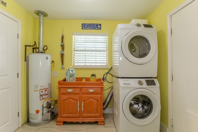 washroom featuring water heater and stacked washer and dryer