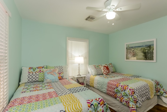 bedroom with ceiling fan and hardwood / wood-style flooring