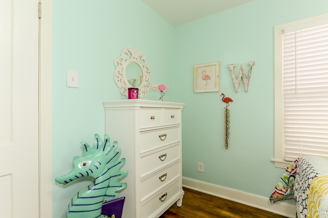 bedroom with dark wood-type flooring