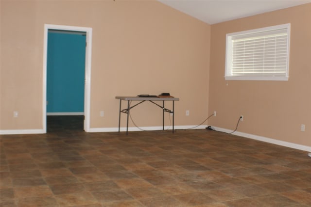 unfurnished room featuring dark tile floors