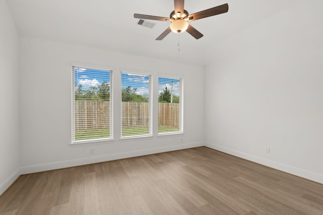 unfurnished room with light wood-type flooring and ceiling fan