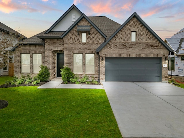 view of front of property featuring a yard and a garage