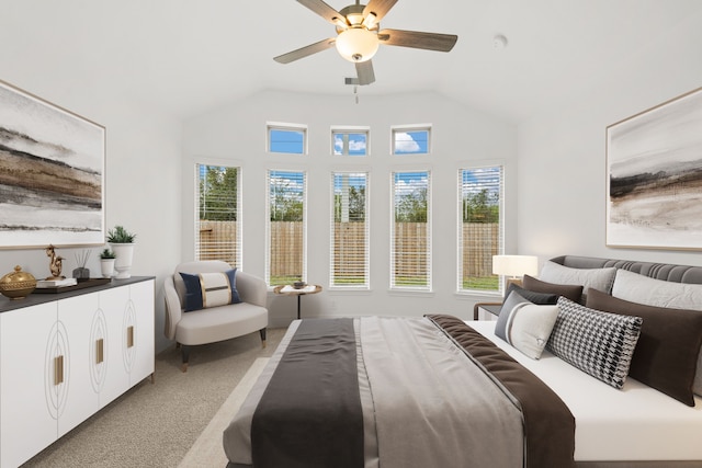 bedroom with ceiling fan, vaulted ceiling, and light colored carpet