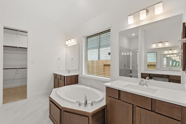 bathroom with vanity, vaulted ceiling, and shower with separate bathtub