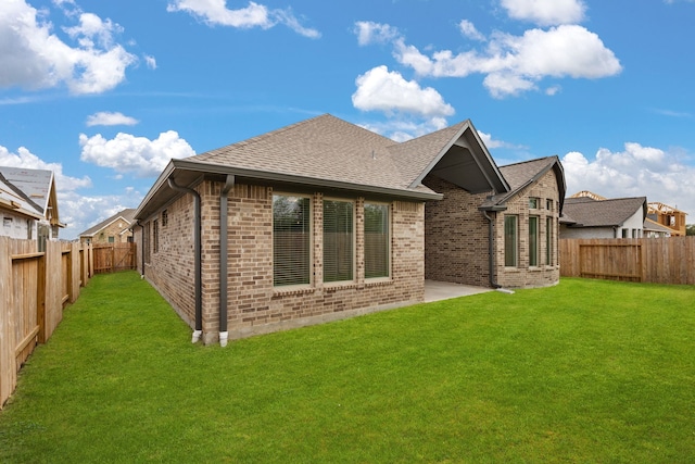 back of property featuring a patio area and a lawn