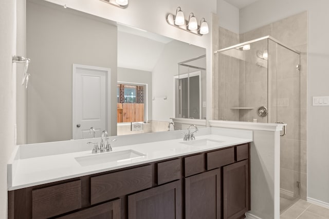 bathroom featuring tile patterned floors, walk in shower, and vanity