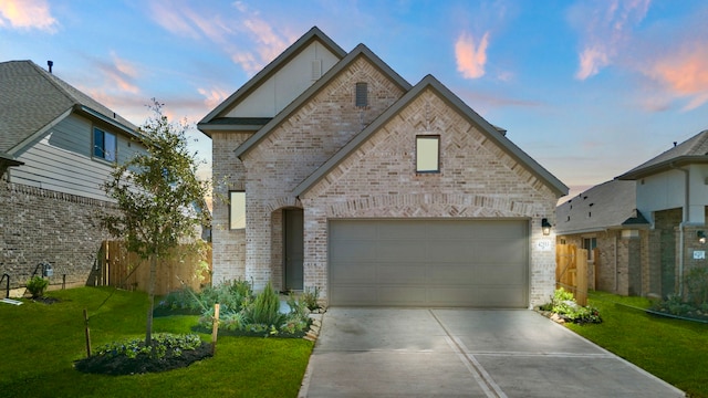 french provincial home with a garage and a yard