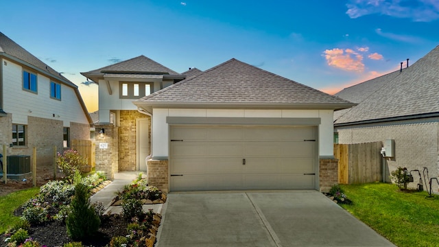 view of front of house with a garage and central AC unit