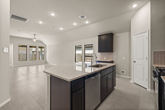 kitchen with a kitchen island with sink, sink, ceiling fan, appliances with stainless steel finishes, and lofted ceiling