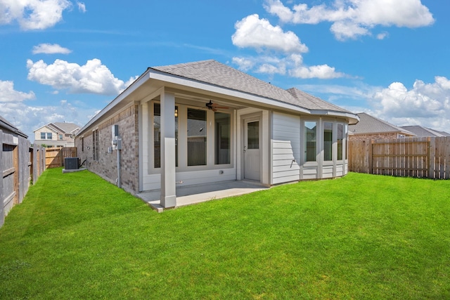 back of property featuring ceiling fan, a lawn, a patio, and central AC