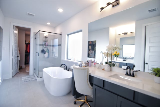 bathroom featuring vanity, separate shower and tub, and tile floors