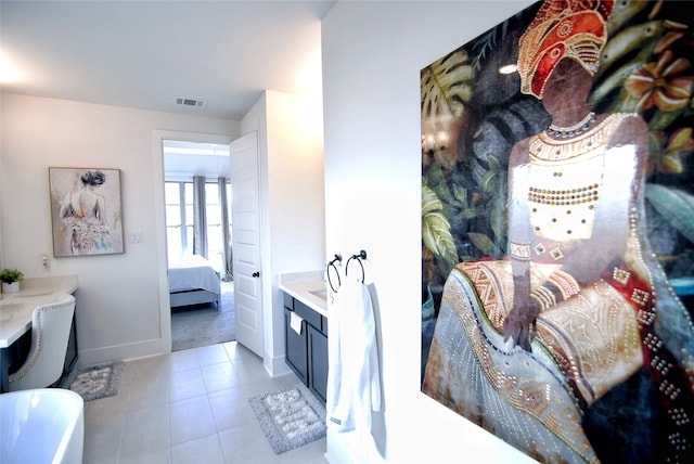 bathroom featuring a bath, vanity, and tile floors