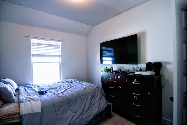 carpeted bedroom featuring lofted ceiling