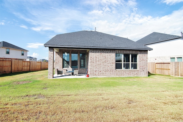 rear view of property featuring a patio and a yard