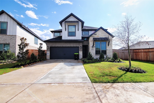 view of front of property with a front yard and a garage