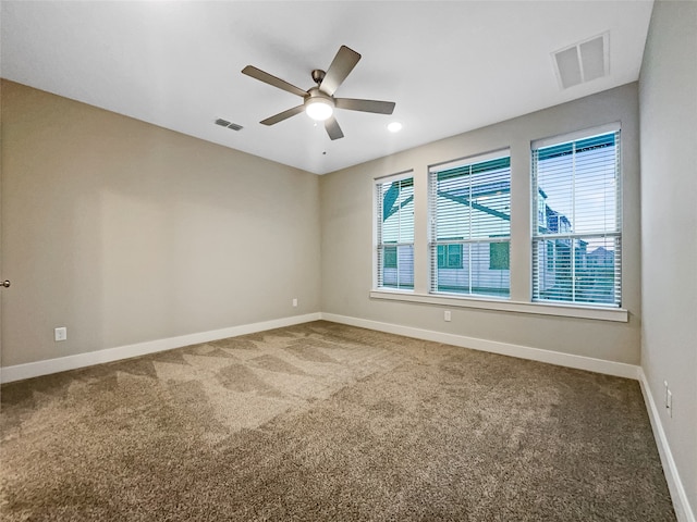 unfurnished room featuring ceiling fan and carpet flooring