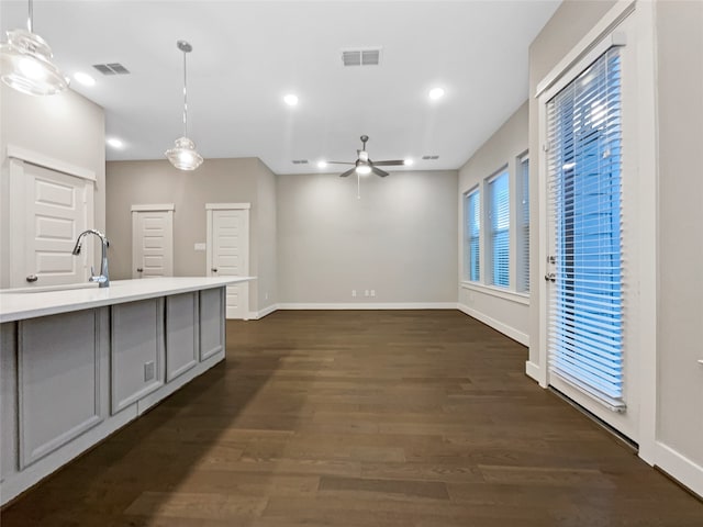 kitchen featuring hanging light fixtures, ceiling fan, gray cabinetry, and dark hardwood / wood-style floors