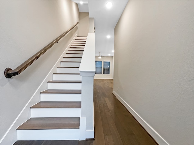 stairs with dark hardwood / wood-style flooring