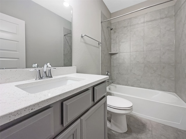 full bathroom featuring vanity, toilet, tiled shower / bath, and tile flooring