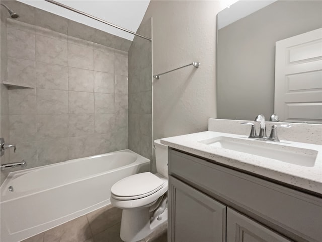 full bathroom featuring tile floors, tiled shower / bath, vanity, and toilet