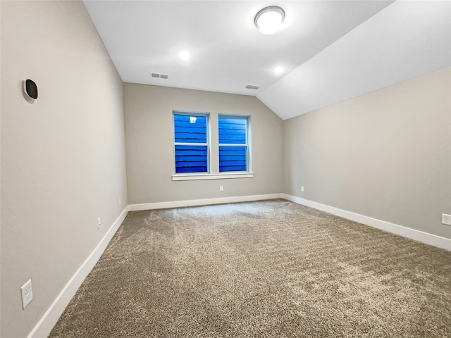 empty room with carpet and lofted ceiling