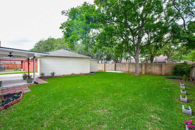 view of yard featuring ceiling fan and a patio area