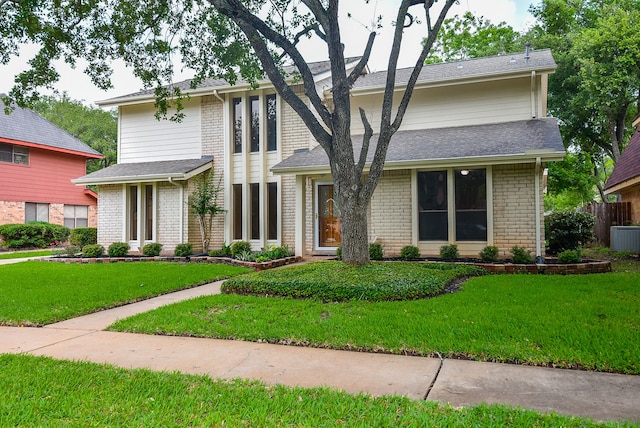 view of front of home featuring a front lawn and central air condition unit