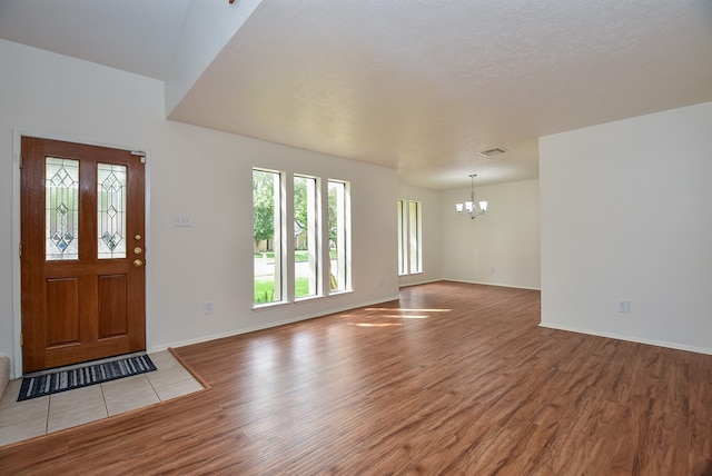 foyer with a chandelier and hardwood / wood-style floors