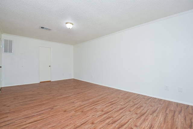 unfurnished room featuring light hardwood / wood-style flooring, crown molding, and a textured ceiling