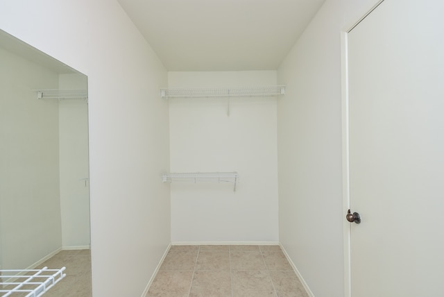 walk in closet featuring tile floors